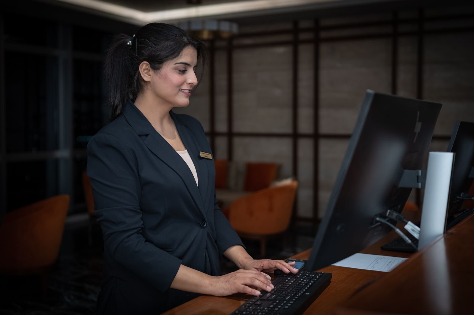 Front-desk staff working at the reception counter