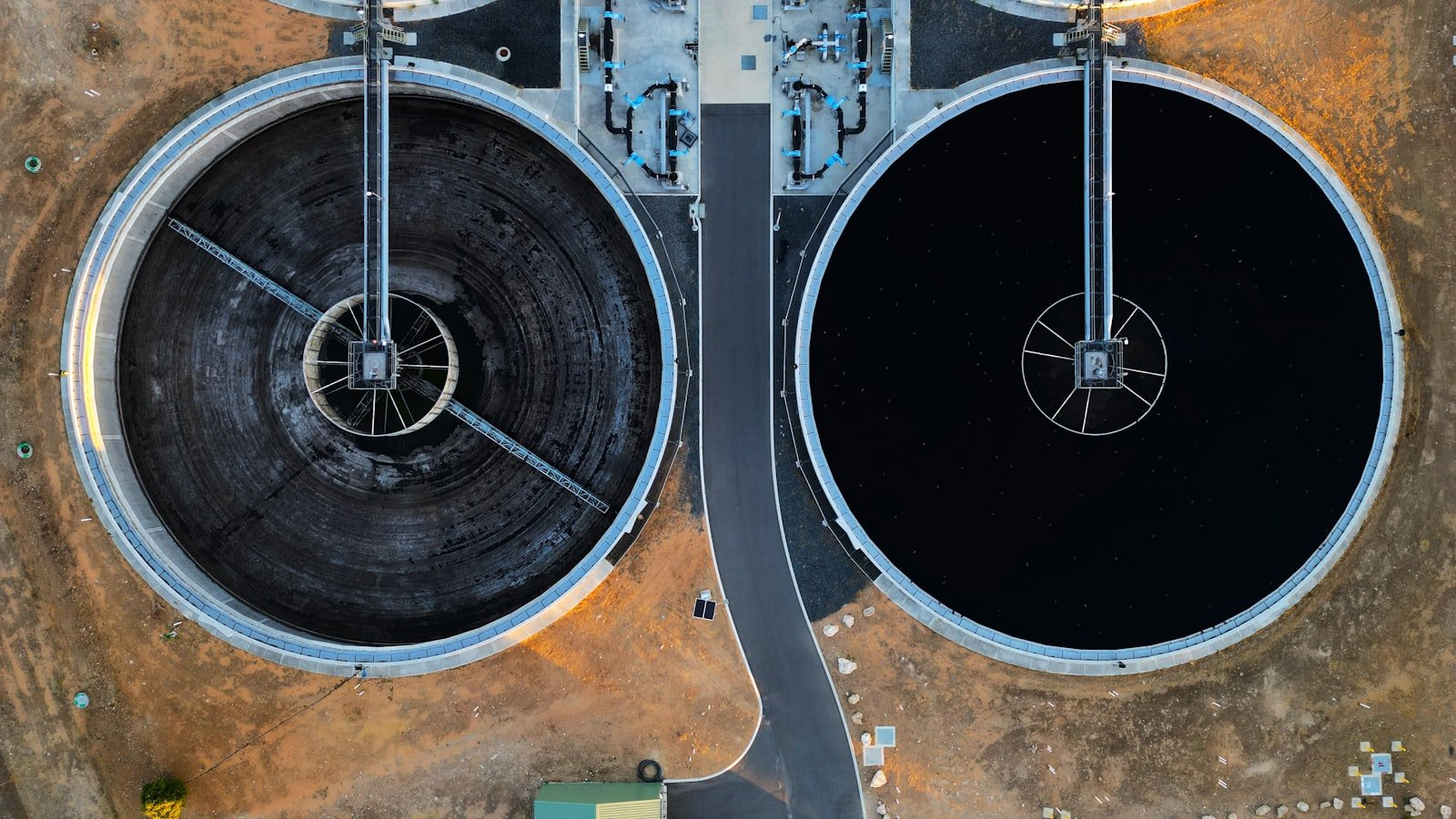 Aerial view of two circular clarifier tanks at a treatment plant